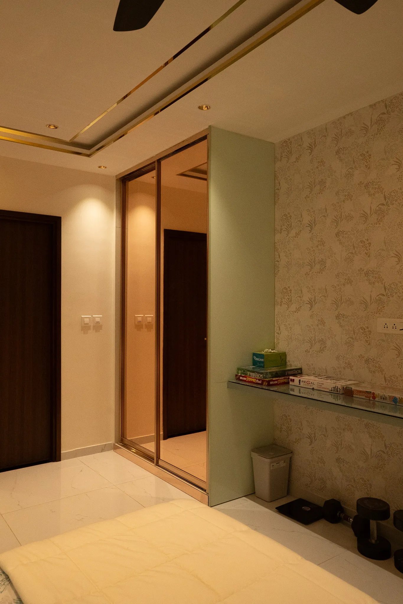 Bronze-mirror wardrobe beside the bedroom entrance — Divyarjuna
